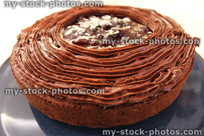 Stock image of decorated chocolate cake with rich ganache icing / frosting
