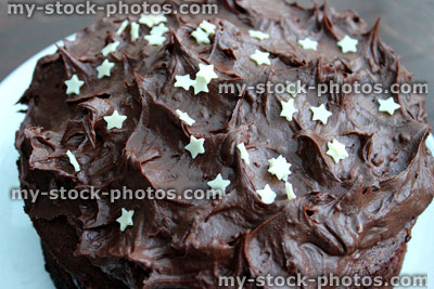 Stock image of decorated chocolate cake with rich ganache icing / frosting