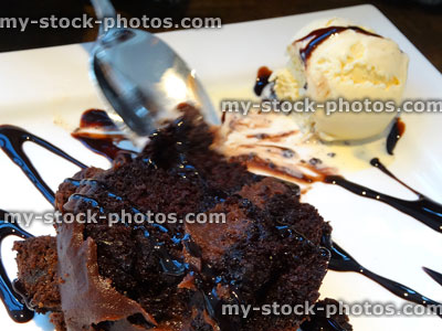 Stock image of hot chocolate fudge cake with vanilla ice cream scoop