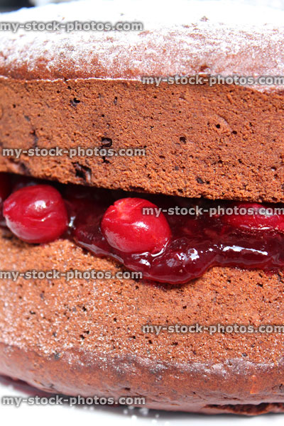 Stock image of homemade chocolate cake / Black Forest gateau, cherries, cherry jam, icing sugar