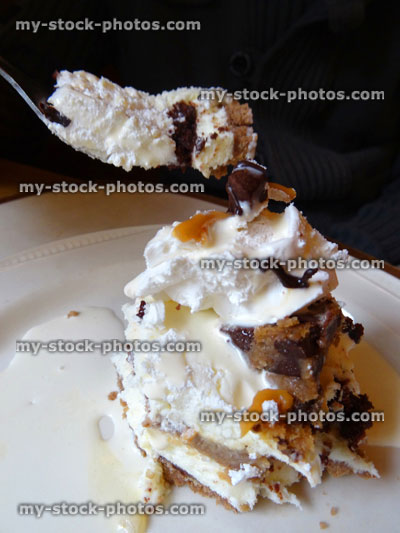 Stock image of eating homemade chocolate toffee fudge / caramel cheesecake, cake slice, cream jug