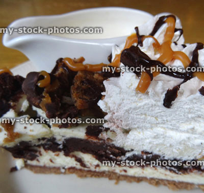 Stock image of homemade chocolate toffee fudge / caramel cheesecake, cake slice, cream jug