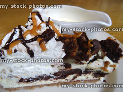 Stock image of homemade chocolate toffee fudge / caramel cheesecake, cake slice, cream jug
