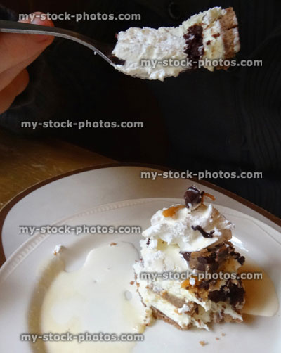 Stock image of eating homemade chocolate toffee fudge / caramel cheesecake, cake slice, cream jug