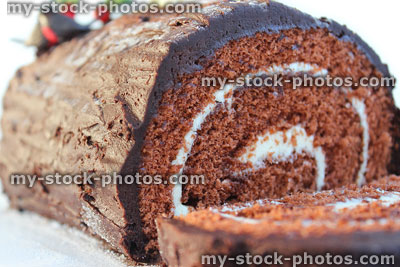 Stock image of Christmas chocolate log / Swiss roll with frosting / icing