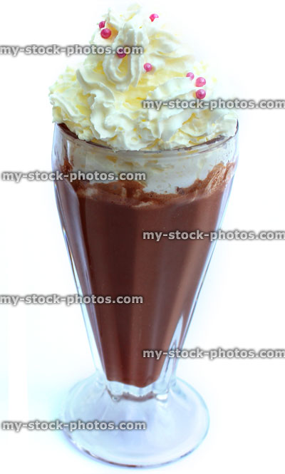 Stock image of chocolate milkshake topped with whipped cream, American diner glass