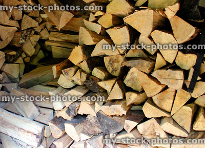 Stock image of pile of timber / chopped logs in shed, firewood for wood burner