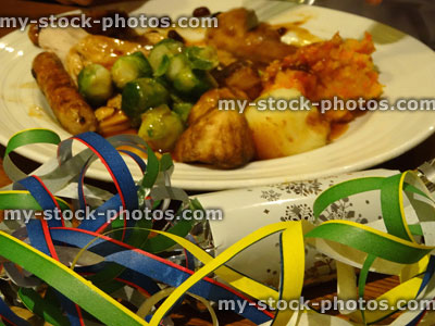 Stock image of Christmas dinner, roast turkey, Brussels sprouts, gravy, roast potatoes, crackers, streamers