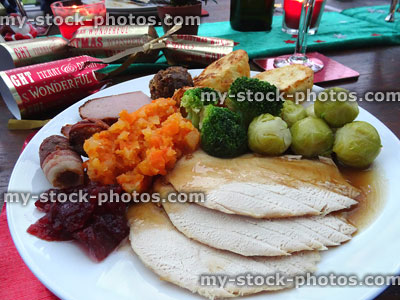 Stock image of Christmas dinner with turkey, sprouts, cranberry sauce, crackers