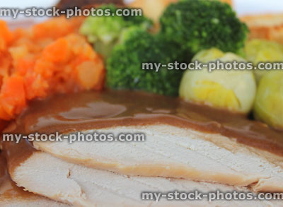 Stock image of roast turkey / chicken slices, dinner with vegetables and gravy