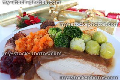 Stock image of Christmas dinner on plate with sprouts, crackers, trimmings