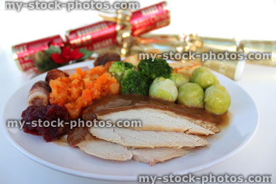 Stock image of Christmas turkey dinner with winter vegetables, sprouts, crackers