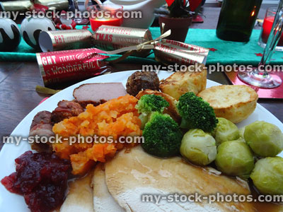 Stock image of Christmas dining table with roast turkey dinner, vegetables