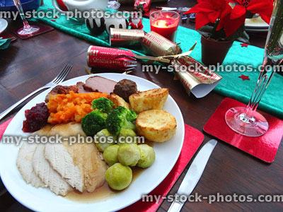 Stock image of Christmas dinner on decorated dining table with roast-turkey