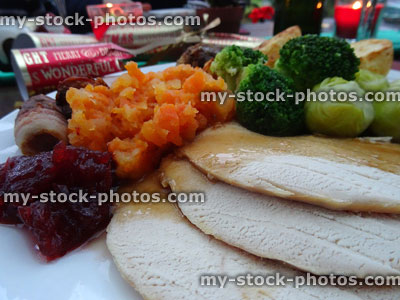 Stock image of roast turkey slices on Christmas dinner plate, gravy