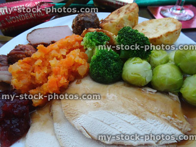 Stock image of roast turkey Christmas dinner, gravy, sprouts, mashed-carrot, potatoes