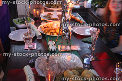 Stock image of Christmas dinner table with evening buffet food and drink