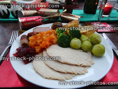 Stock image of Christmas dinner plate with roast turkey, sprouts, crackers