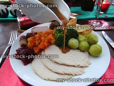 Stock image of gravy being poured over Christmas dinner roast turkey