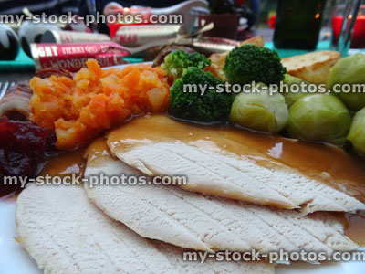 Stock image of Christmas dinner close up with slices of roast turkey / gravy