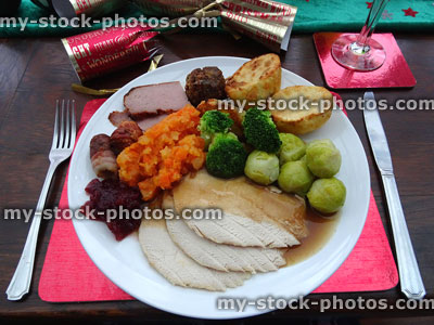 Stock image of Christmas dinner setting with plate of food, turkey, gravy