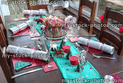 Stock image of dining table at Christmas time, decorations, crackers, velvet-runner