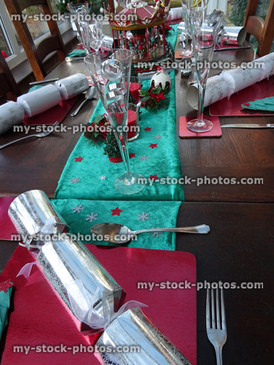 Stock image of Christmas dinner table with crackers, wine-glasses, festive decorations