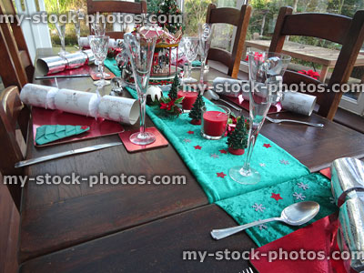 Stock image of conservatory dining table with Christmas-decorations, placemats, crackers, wine-glasses