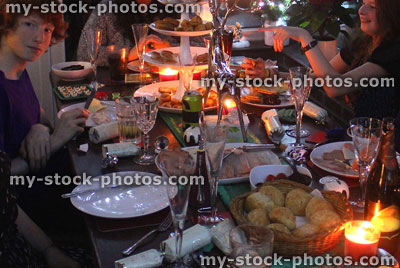 Stock image of dining table with Christmas buffet food at night