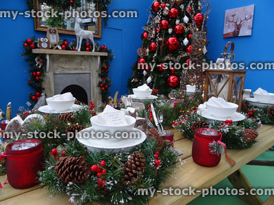 Stock image of Christmas dinner table place settings, tree decorations, fireplace
