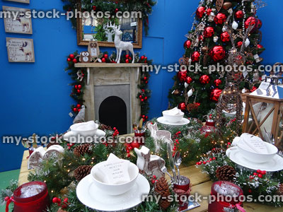 Stock image of dining-table set for Christmas with decorations, tree, fireplace