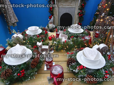 Stock image of place settings on Christmas dinner table with fireplace