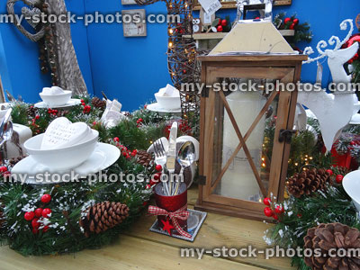 Stock image of artificial Christmas wreaths and dining table place settings