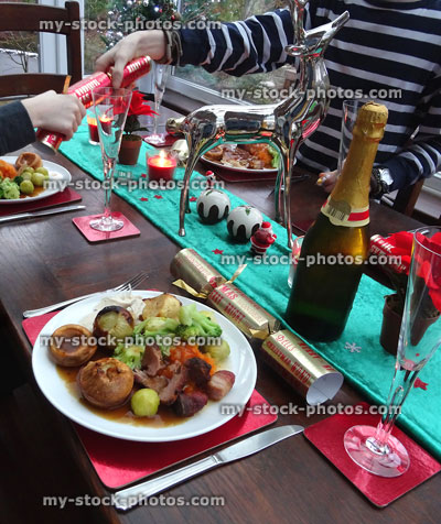 Stock image of table laid for Christmas roast turkey dinner, pulling crackers