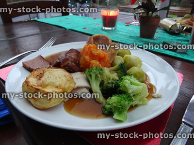 Stock image of Christmas dinner with seasonal vegetables on red placemats