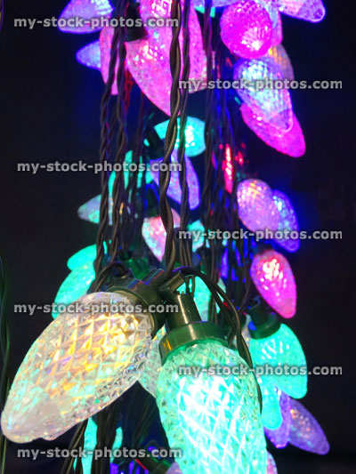 Stock image of tangled multi coloured Christmas tree fairy light bulbs, twinkling xmas lights