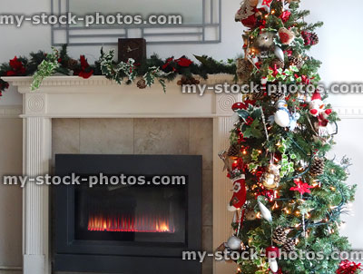Stock image of modern gas fire with garland, Christmas tree, fairylights