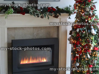 Stock image of contemporary gas fire / fireplace with Christmas tree and decorations
