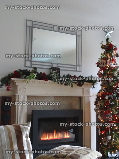 Stock image of modern fireplace with festive garland, Christmas tree decorations