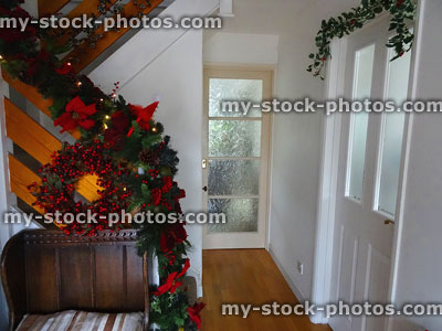 Stock image of hallway decorated with Christmas wreath of berries, garland
