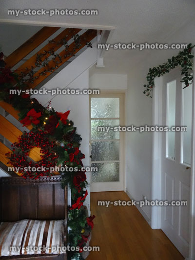 Stock image of hallway with wooden floor and Christmas decorations / wreath