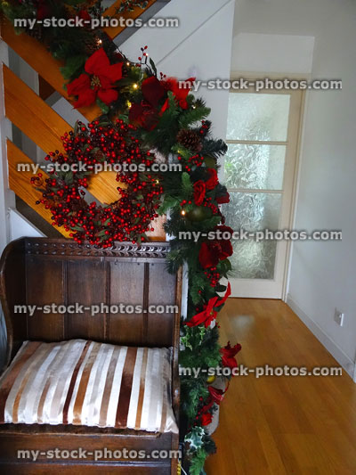 Stock image of wooden stair bannister with Christmas decorations, garland, wreath