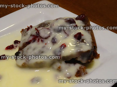Stock image of hot Christmas pudding slice with brandy sauce / custard