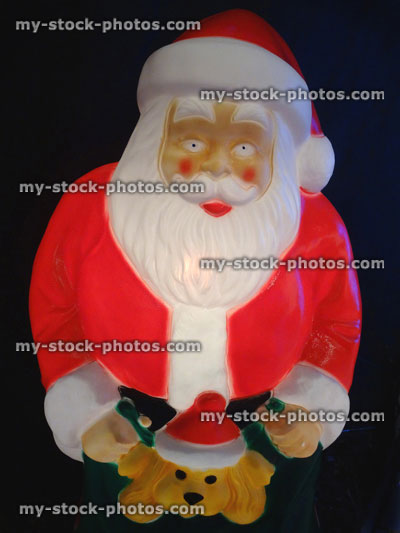 Stock image of large cuddly life size cartoon illuminated Santa Claus / Father Christmas, plastic light, winter display