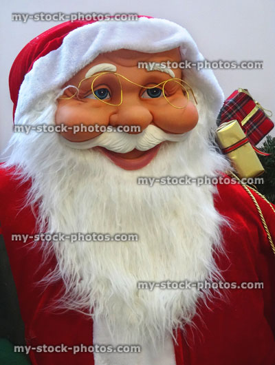 Stock image of large cuddly life size cartoon Santa Claus / Father Christmas, white beard, winter display