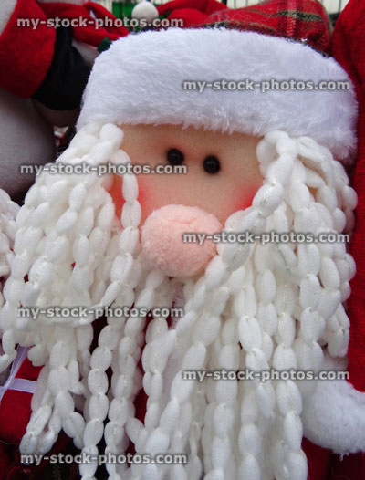 Stock image of cuddly toy cartoon Santa Claus / Father Christmas, dreadlocks white beard, winter display