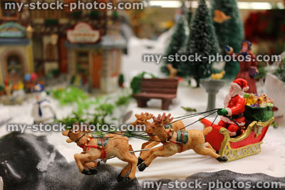 Stock image of Christmas model Santa Claus with toy reindeer sleigh