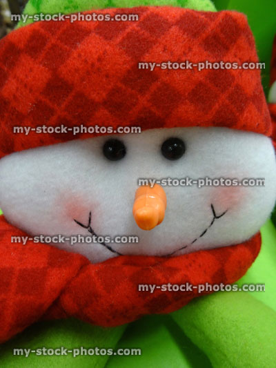 Stock image of large cuddly toy cartoon snowman, seasonal winter Christmas display, snow