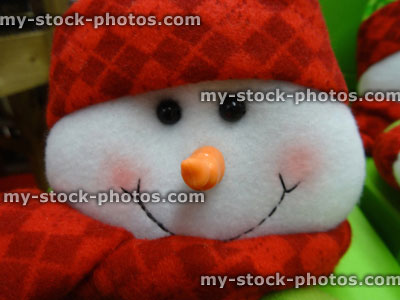 Stock image of large cuddly toy cartoon snowman, seasonal winter Christmas display, snow