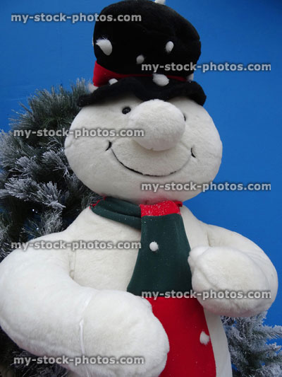 Stock image of large cuddly lifesize cartoon snowman, seasonal winter Christmas display, snow